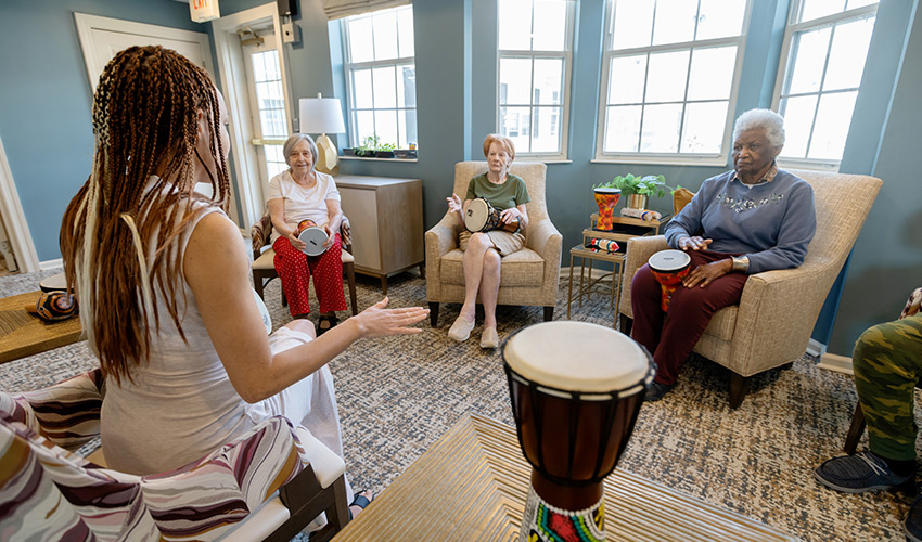 People participating in a drumming class.
