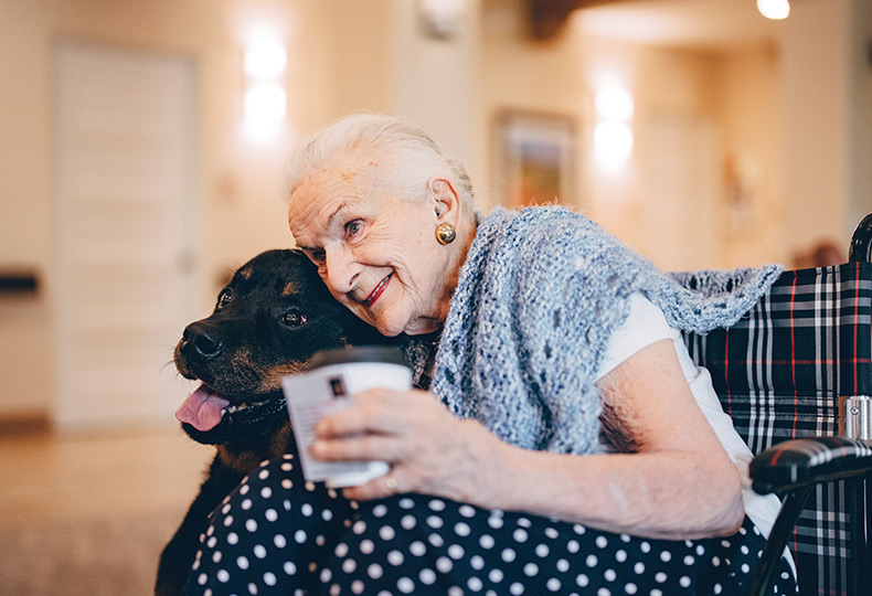 A resident hugging a dog.