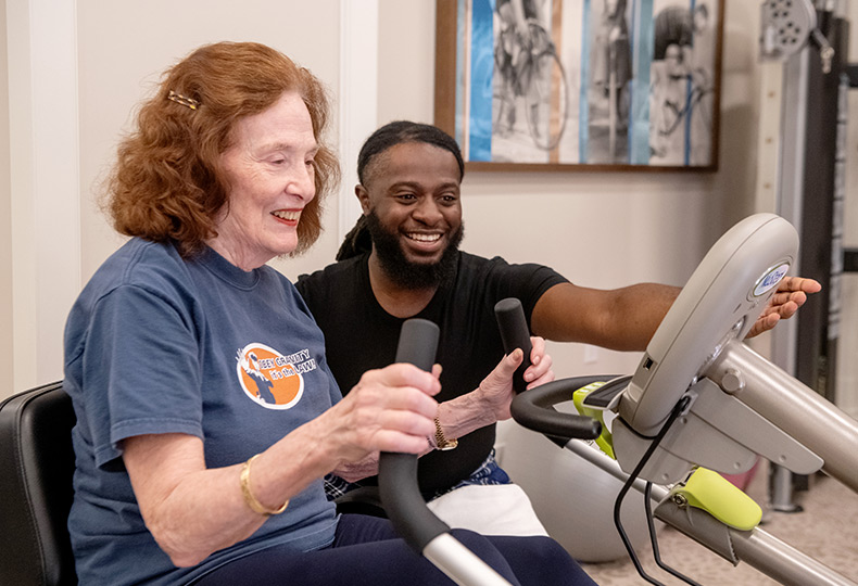 Resdient working out with a caregiver.