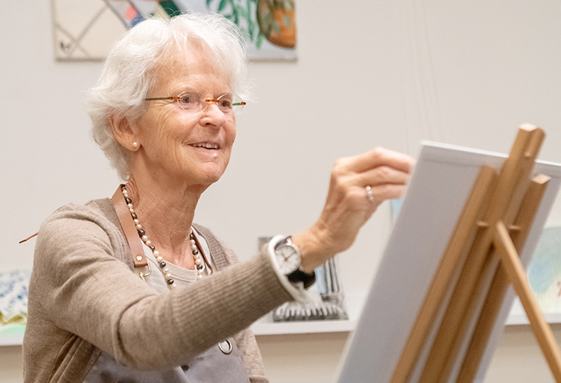 Happy resident painting.