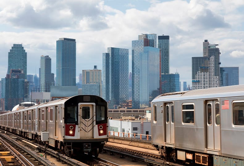 New York trains with city skyline view.