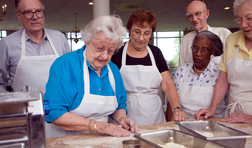 A group of residents learning how to bake.
