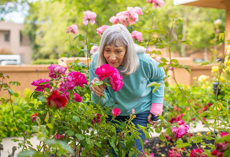 Resident smells flowers.