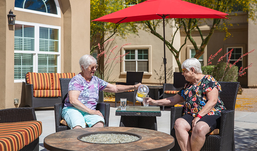 Two people having drinks on the patio.