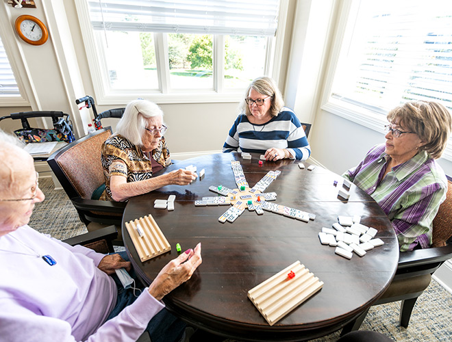A group of residents playing games at a table.