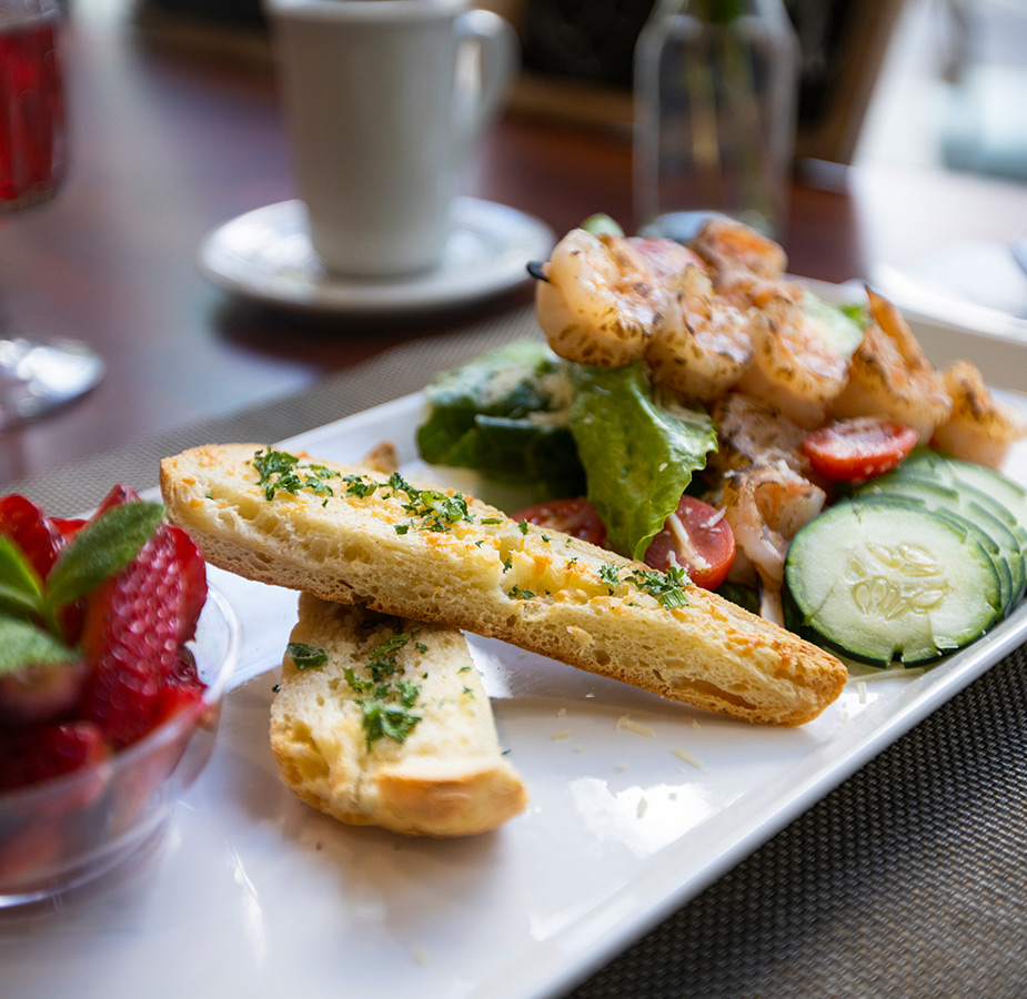 Toasted bread with shrimp on plate.