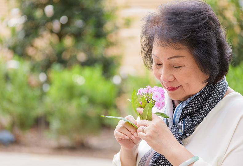 A resident smelling flowers.