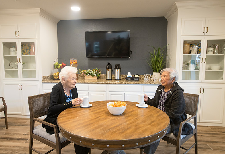 Two residents having coffee.