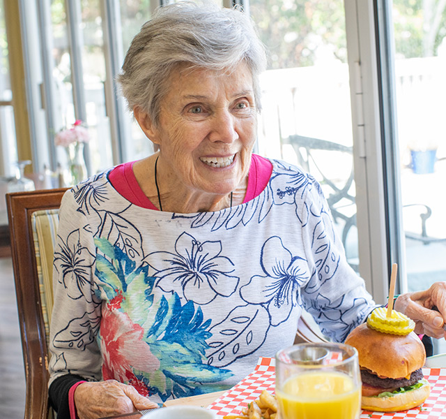 A resident is eating in the dining area.