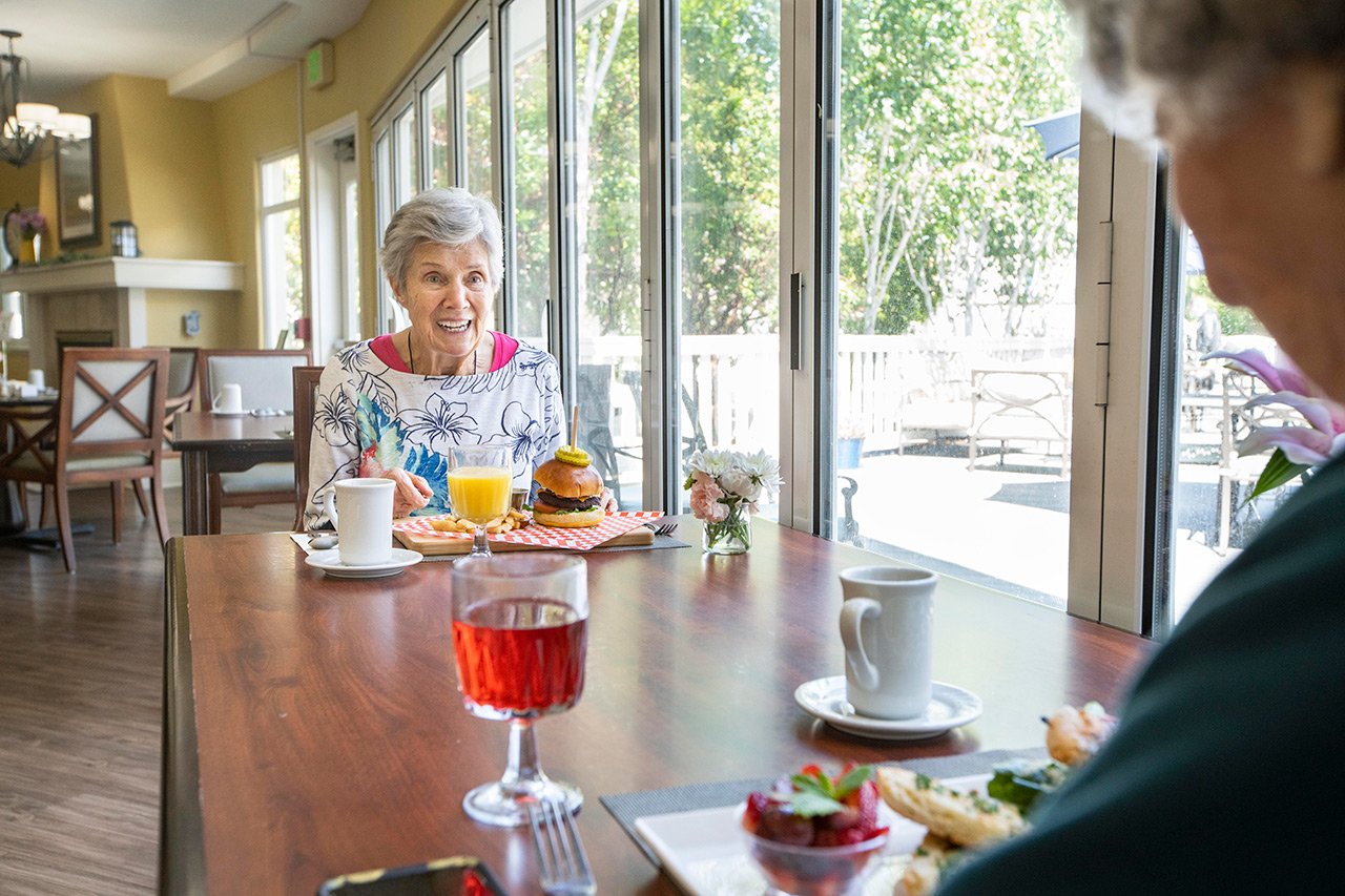 Residents enjoy lunch and a glass of wine.