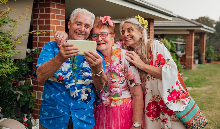 A group of people in Hawaiian shirts on the phone.