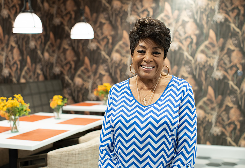 A resident standing in a restaurant at Houston Heights.