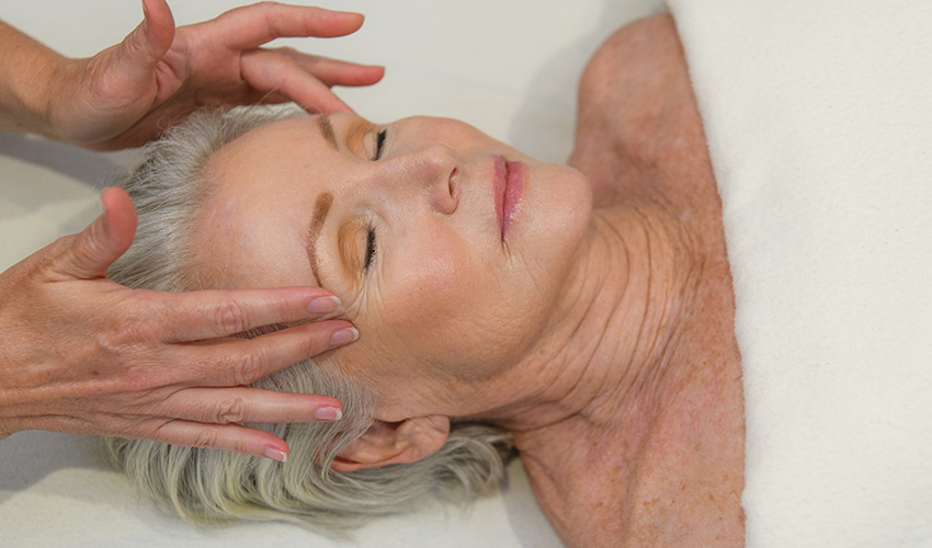 A woman getting a facial massage.