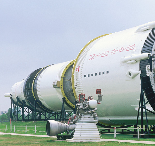 A close up of a space craft outside in a space center.