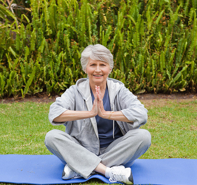 A resident is practicing yoga outside.