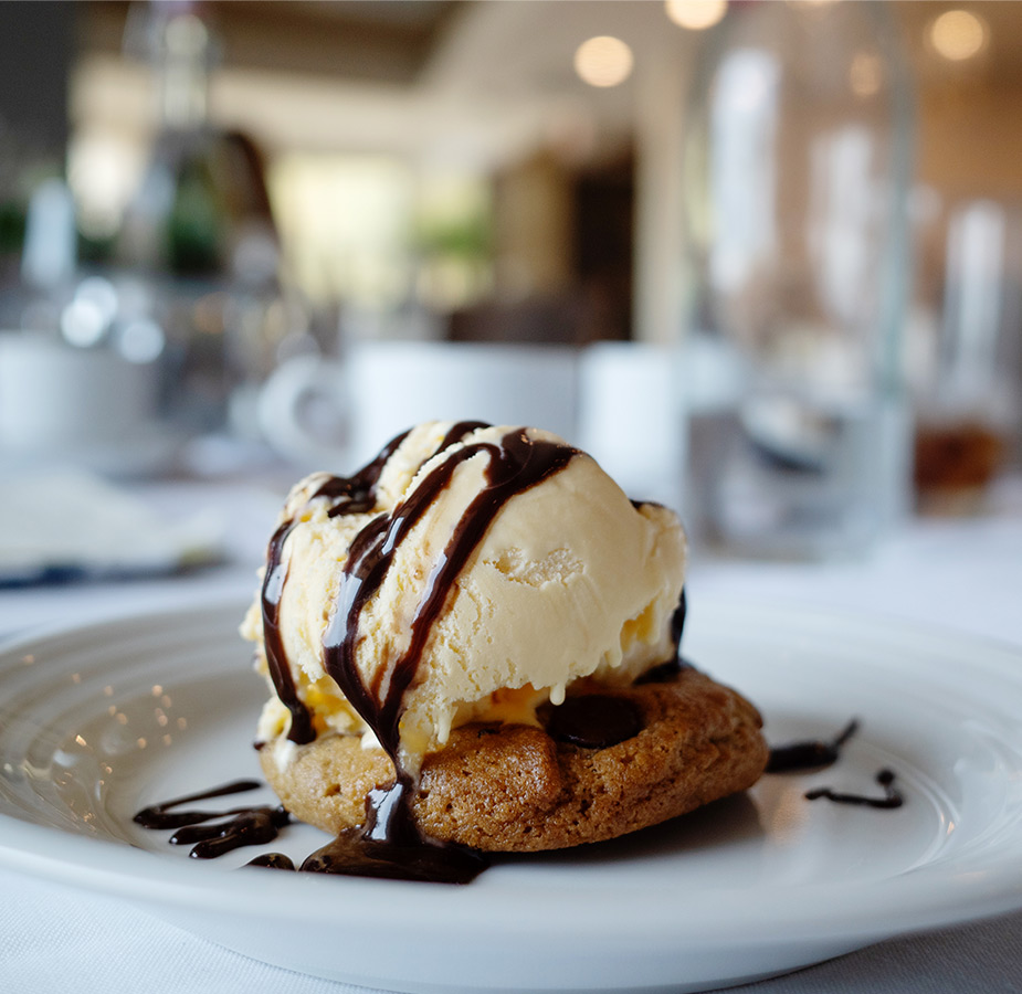 A cookie with ice cream on top.