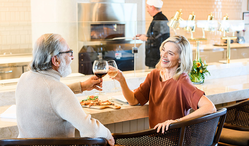 Two people toasting with wine.