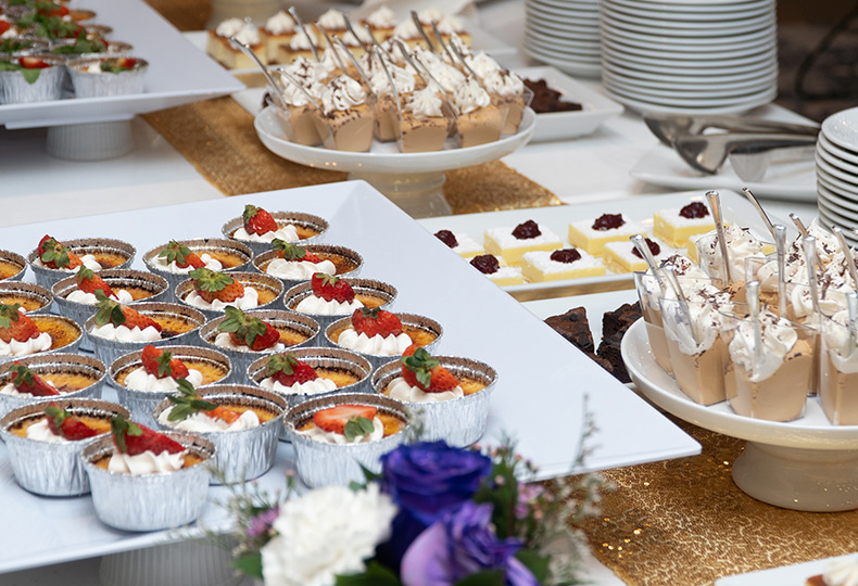 A bunch of bite sized desserts on a table.