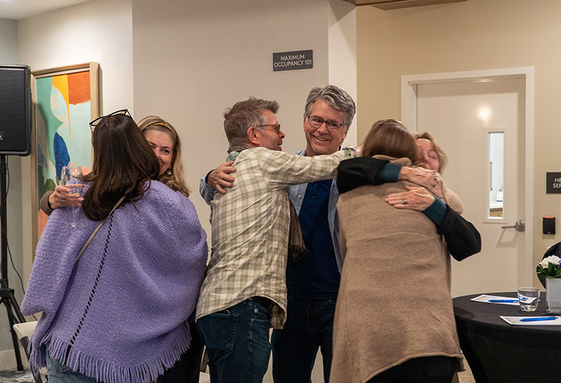 A bunch of people hugging.