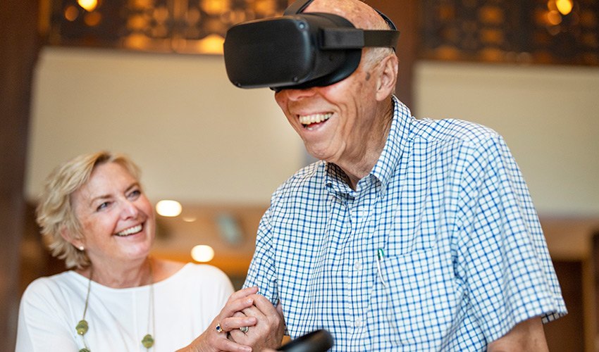 People playing with a VR headset.