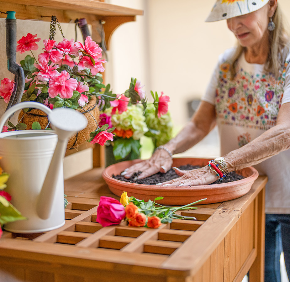 A resident working at a gardening bench.