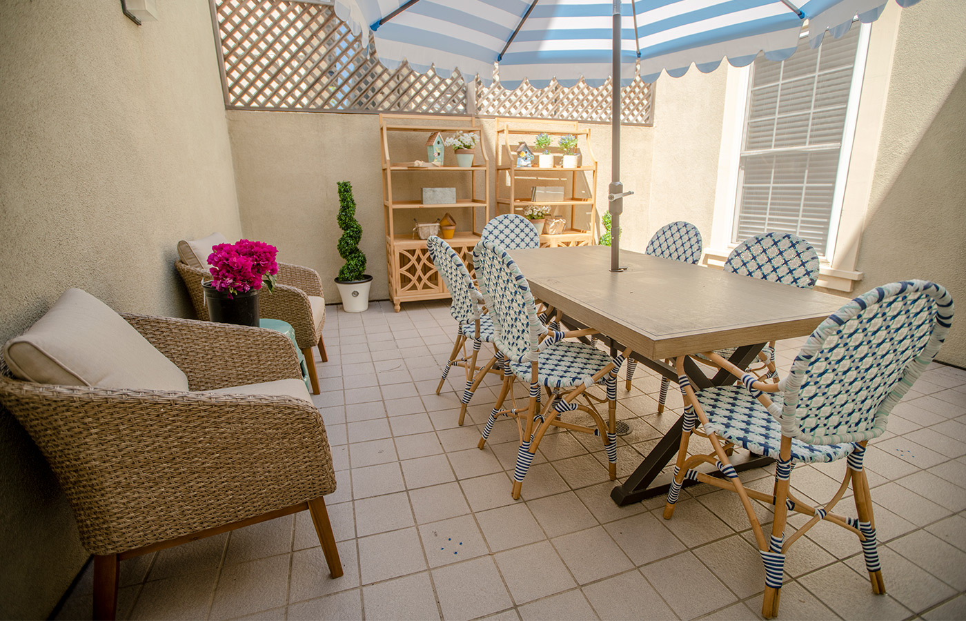 sunny patio area with patio furniture and umbrella