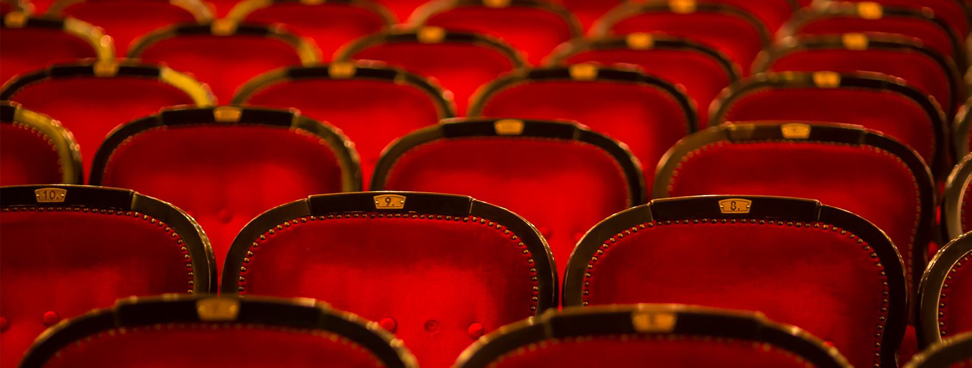 close up of red theater chairs
