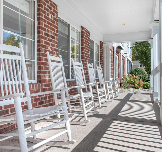 front porch with several rocking chairs