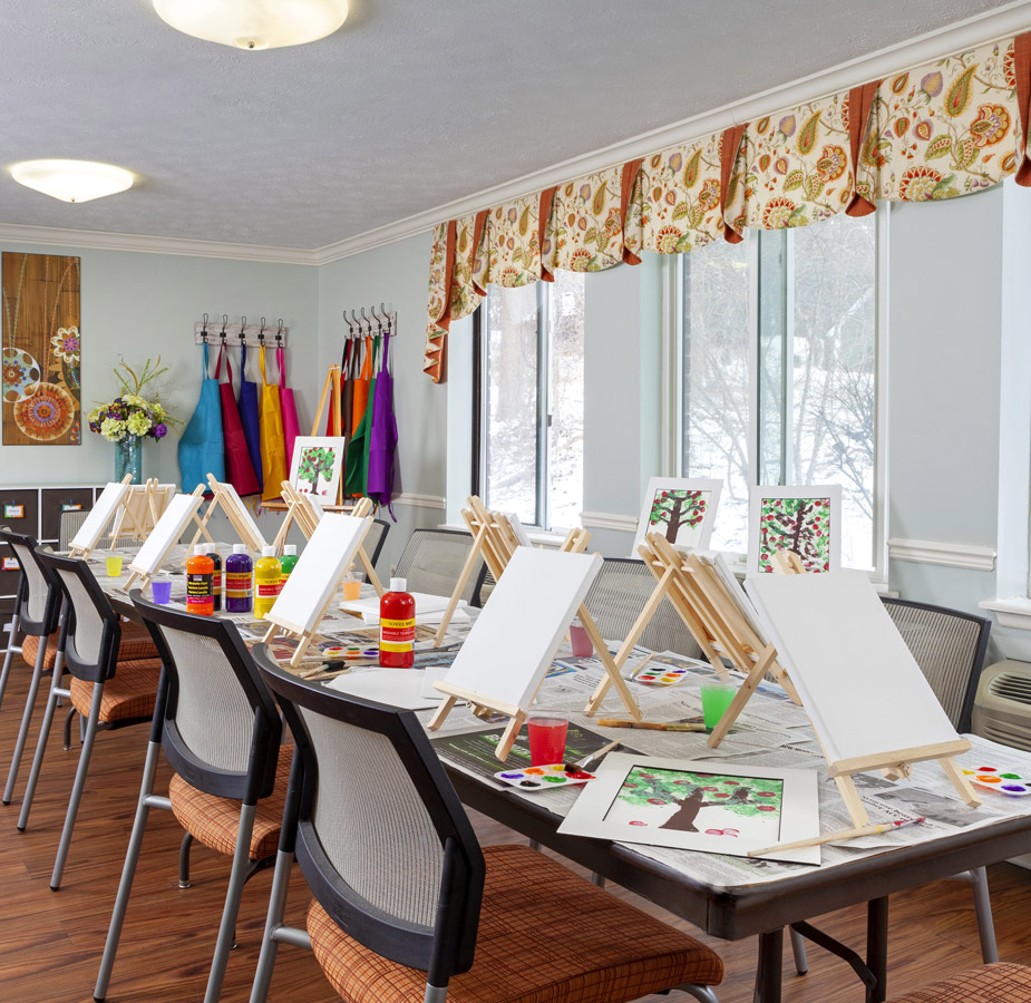 A table with canvases and paint materials.
