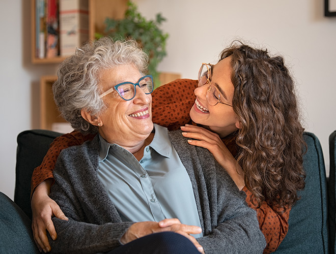 A resident is smiling at a loved one.