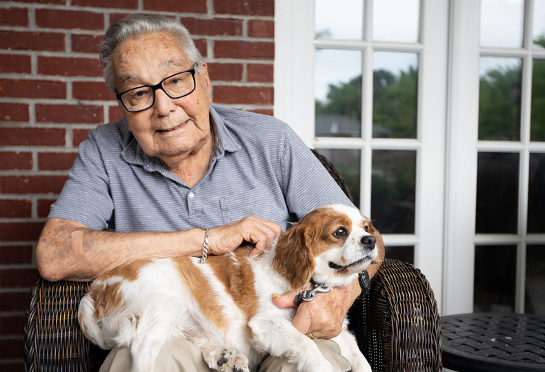 A resident is holding a dog.