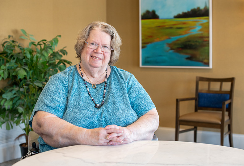 A resident is seated at a table.
