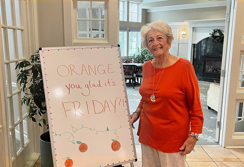 A person in the lobby by a standing sign.