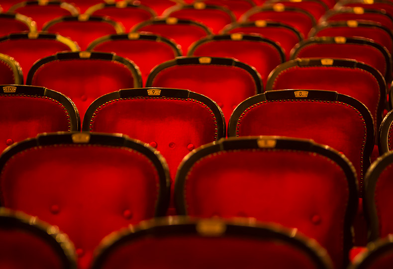 Red chairs in a theater.