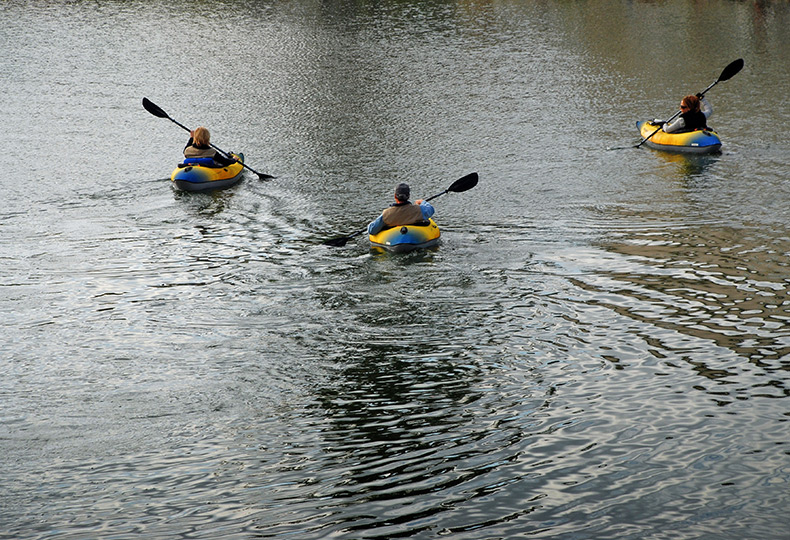 Three people are kayaking.