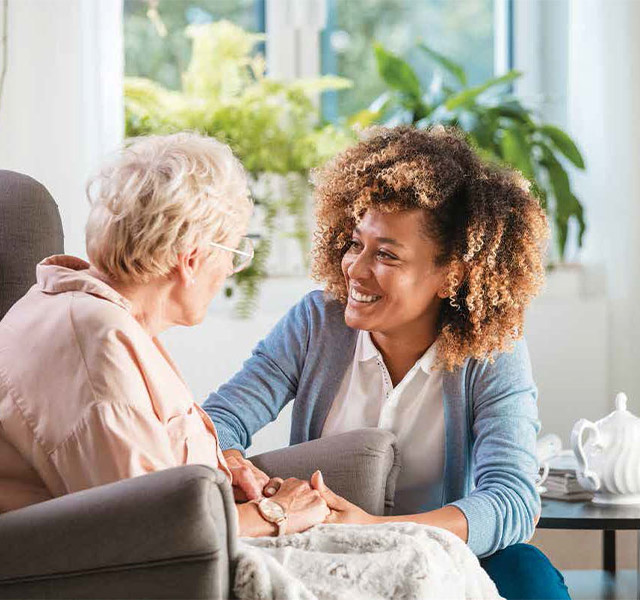 Caregiver greets a resident.