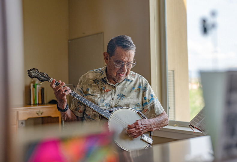 A resident plays banjo.
