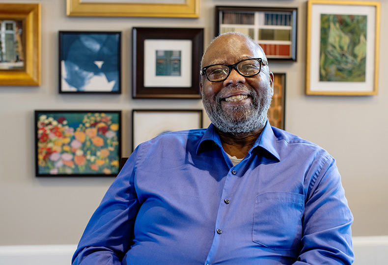 A resident is sitting down and smiling.