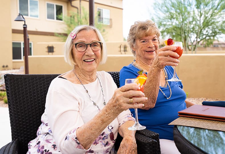 Two residents are having cocktails together.