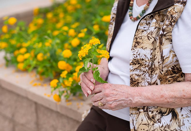 A resident is holding flowers.