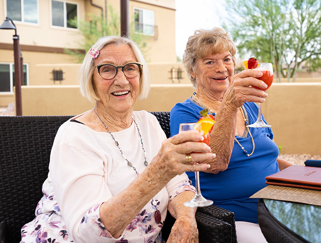 Two residents are having cocktails together.
