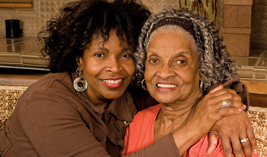 A mother and daughter hugging.