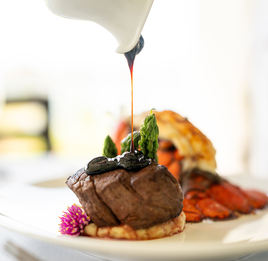Steak and lobster on a plate.