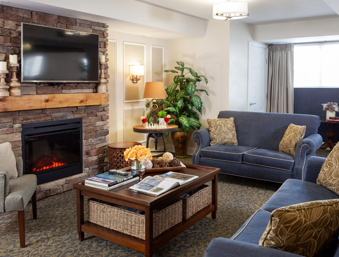 Seating area by fireplace at Pinebrook.
