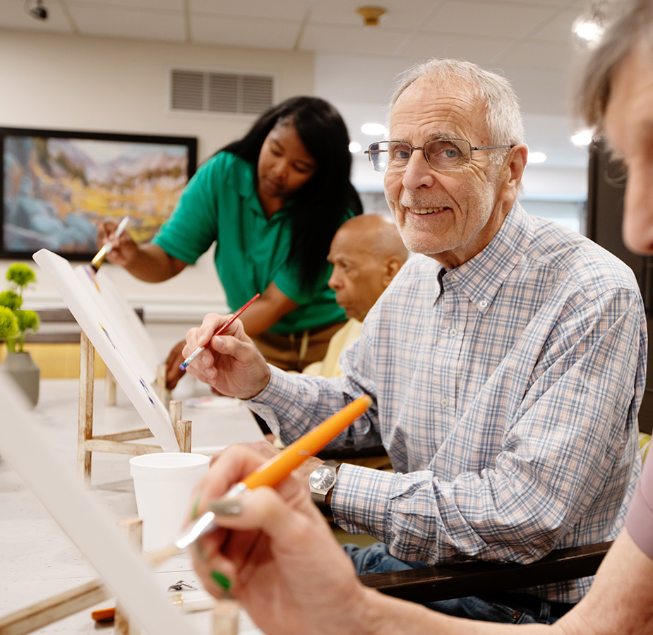 A group of people painting in a class.