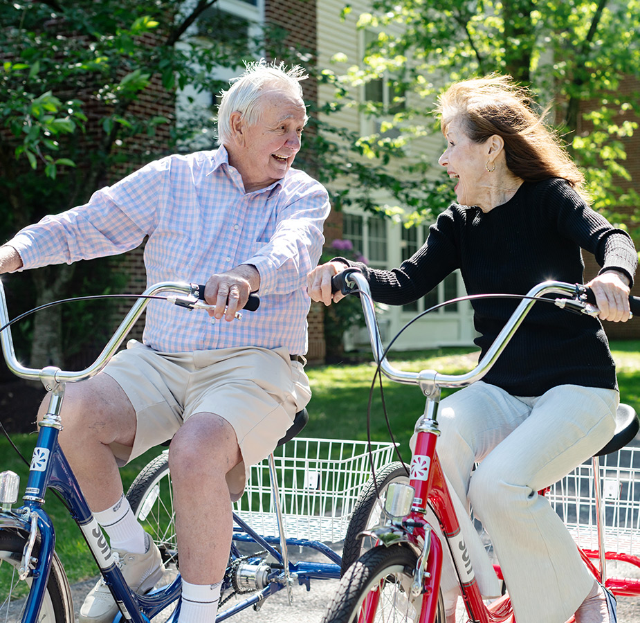 Two people riding bikes.