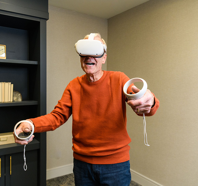 A resident playing with a VR set.