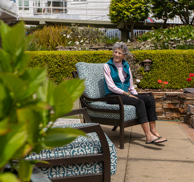 A resident is sitting outside.