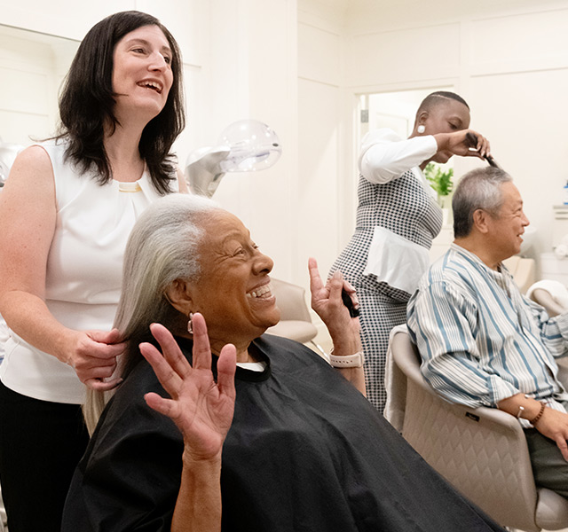 A resident is having their hair done at the salon.