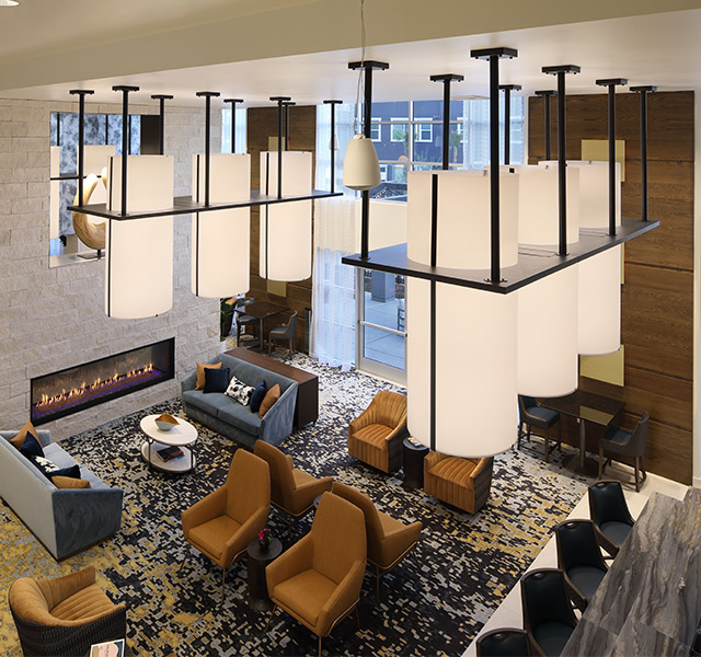 A lounge and bar with seating and a fireplace.